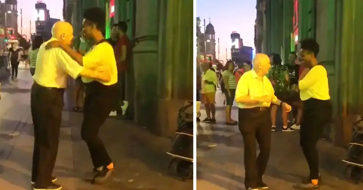 old man dances with busker