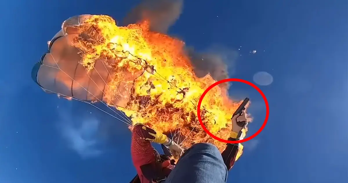 man-set own-parachute-on-fire