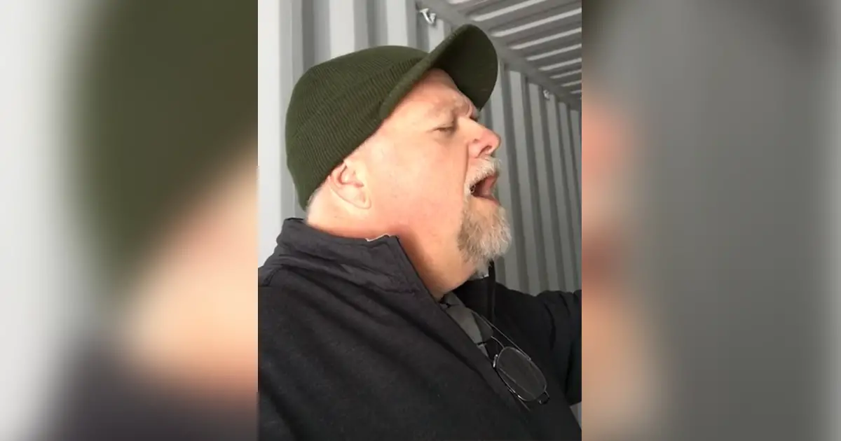 man-sings-in-shipping-container