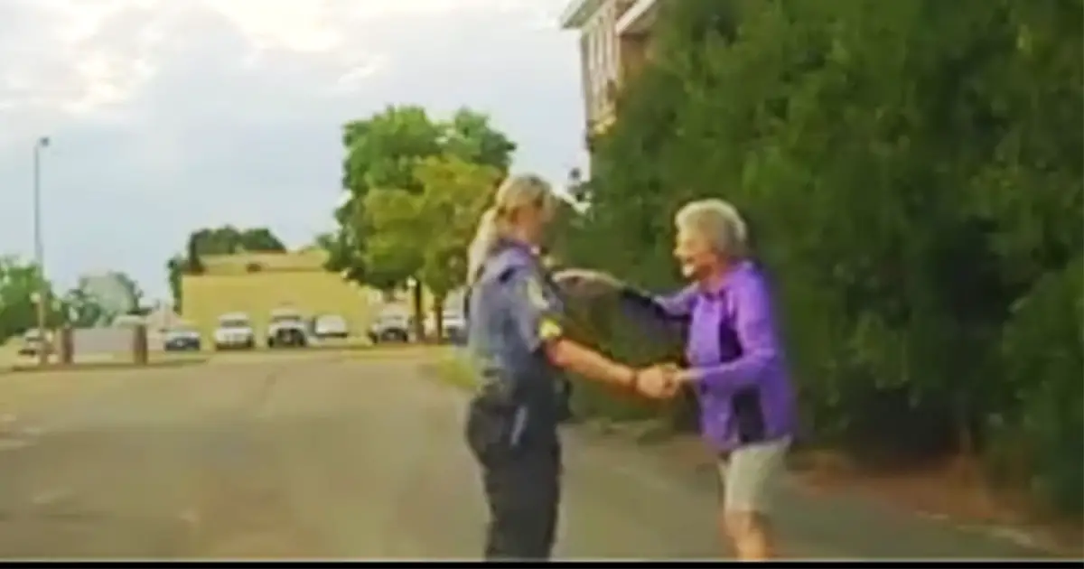 cop-dance-with-elderly-in-road