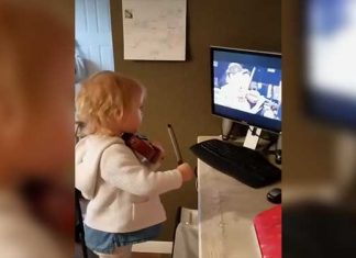 girl playing violin with tv