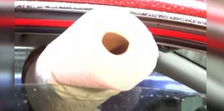 Woman pushes roll of paper