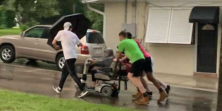 men push elderly woman