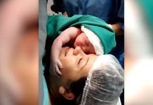 newborn-baby-filmed-clenching-lovingly