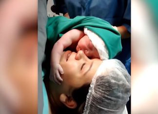 newborn-baby-filmed-clenching-lovingly
