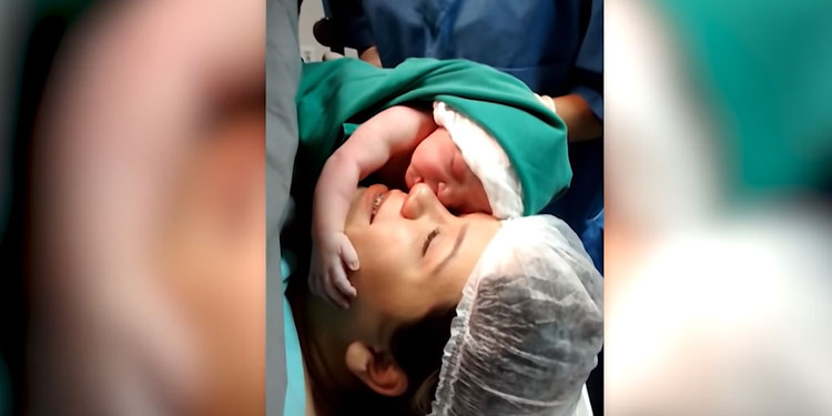 newborn-baby-filmed-clenching-lovingly