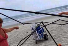 women-stealing-beach-gear